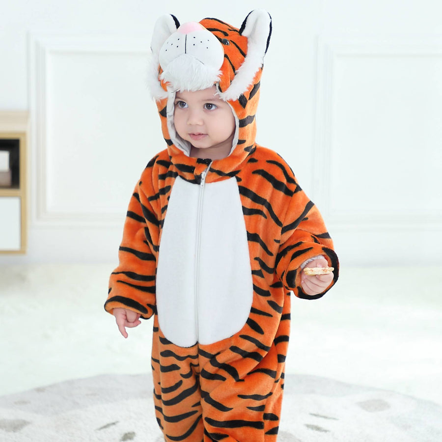 En gullig och mjuk orange tigerdräkt för barn, gjord av bekvämt flanellmaterial med svarta ränder. Dräkten har en vit mage, en huva med små öron och ett detaljerat tigeransikte, samt en liten svans baktill, perfekt för lek eller maskerad.